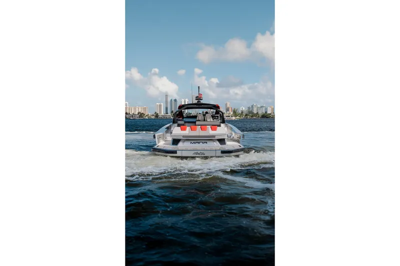 Slide: The Image of Luxury Maori 54XL yacht cruising on water, city skyline in background, 2025 model. - 6