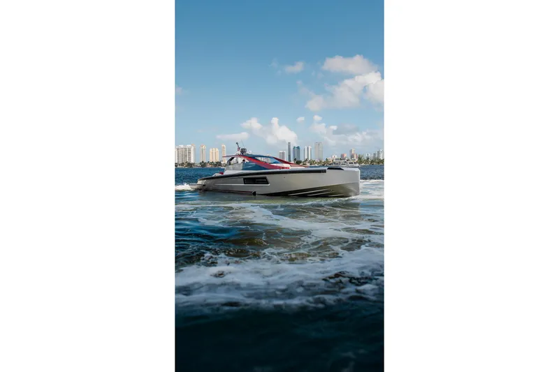 Slide: The Image of Luxury Maori 54XL yacht cruising on water, city skyline in background, 2025 model. - 7