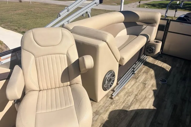 Slide: The Image of 2016 Crest II 230 SLC boat interior with beige seating and wood-style flooring. - 11