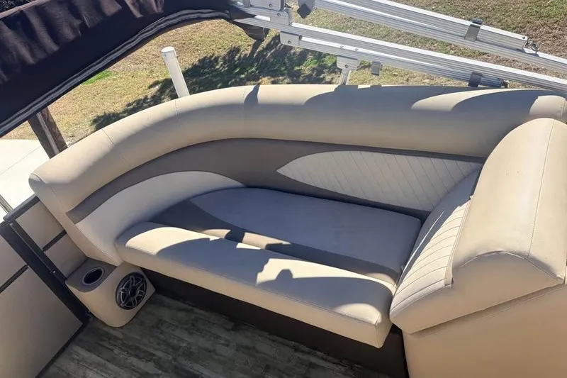 Slide: The Image of 2016 Crest II 230 SLC boat interior with beige seating and speaker. - 14