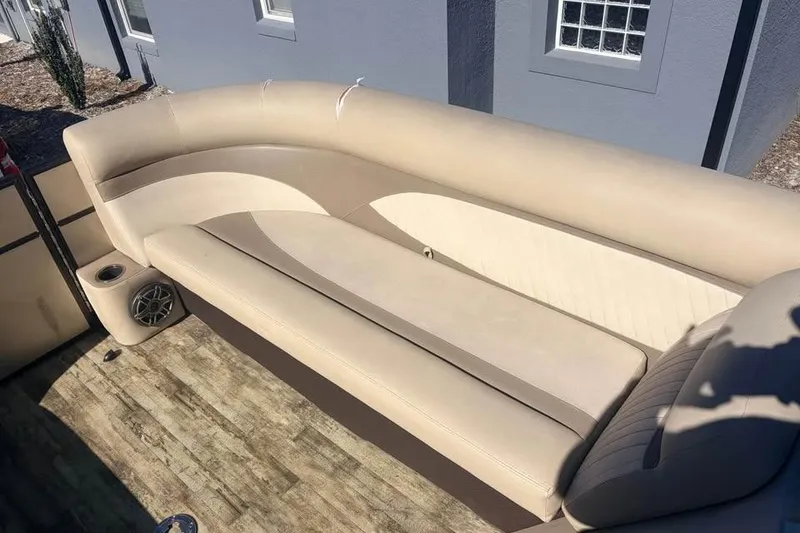 Slide: The Image of 2016 Crest II 230 SLC boat interior with beige seating and speaker. - 21