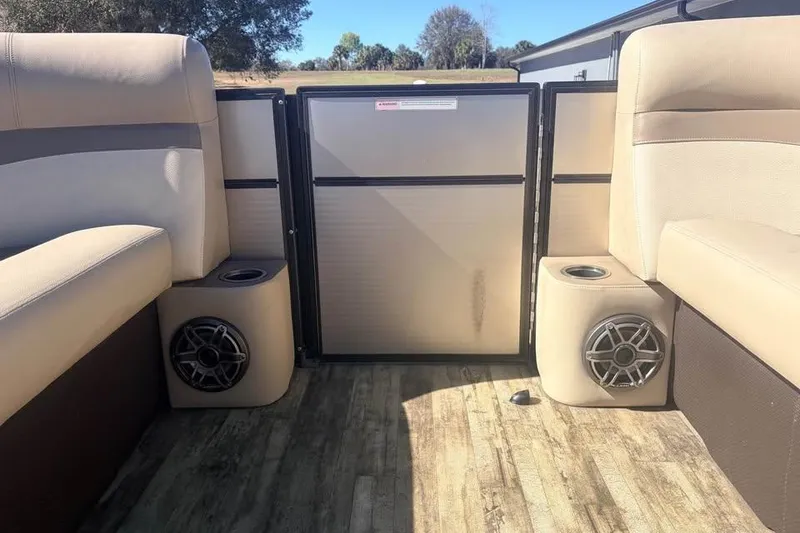 Slide: The Image of Interior of 2016 Crest II 230 SLC boat with beige seating and speakers. - 8