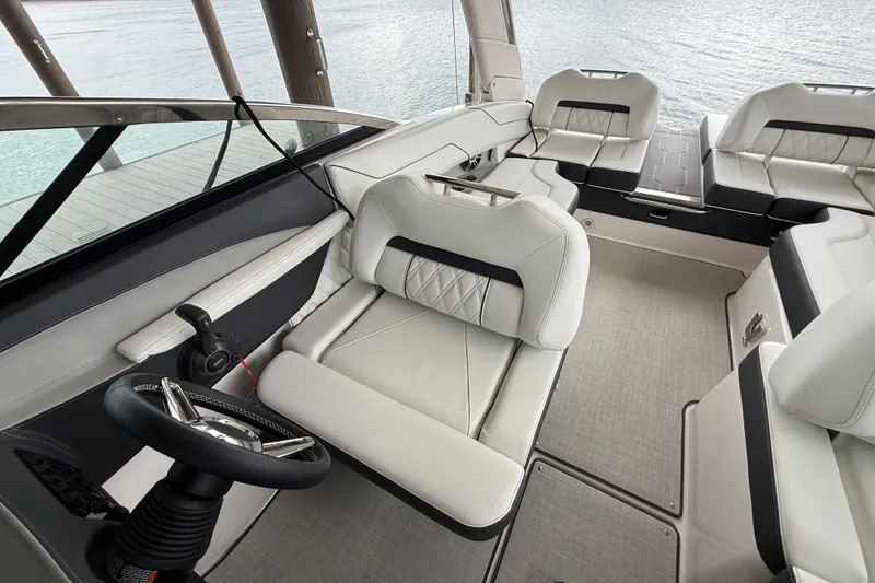 Slide: The Image of 2024 Regal LS4 boat interior with luxurious seating and modern steering wheel design. - 10
