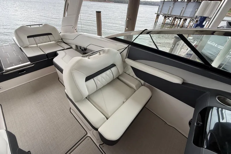Slide: The Image of 2024 Regal LS4 boat interior with luxurious seating and lake view. - 12