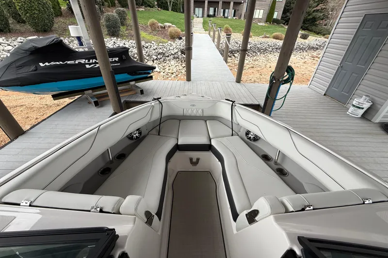 Slide: The Image of 2024 Regal LS4 boat interior with spacious seating at dockside. - 5