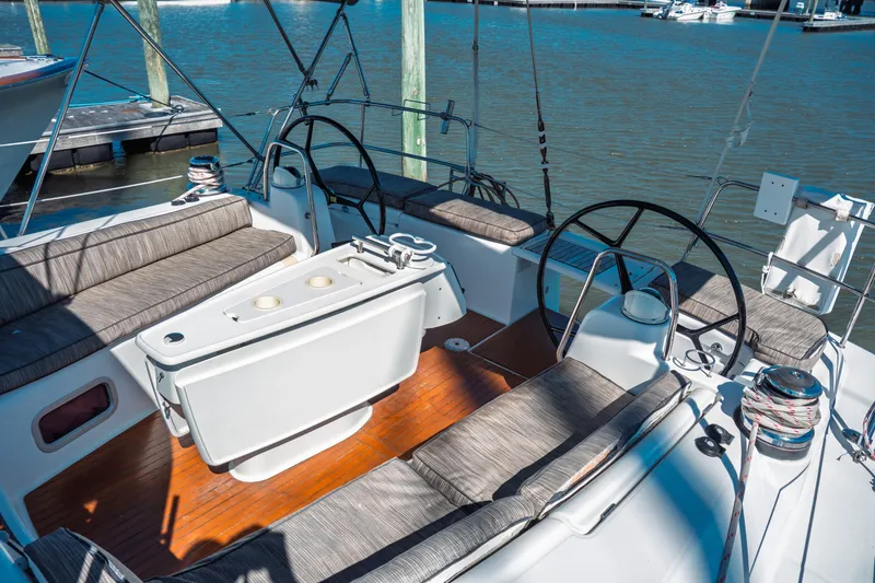 Slide: The Image of 2011 Beneteau Oceanis 50 sailboat cockpit with dual steering wheels and seating. - 11