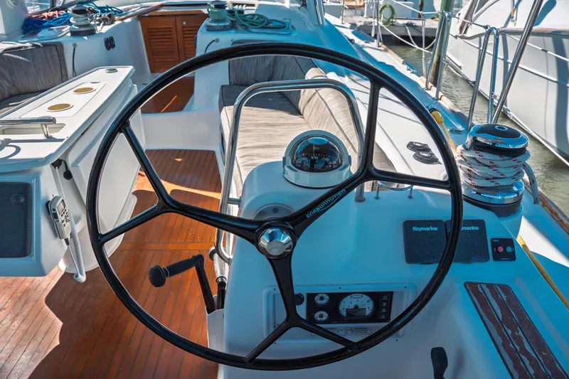 Slide: The Image of Cockpit of 2011 Beneteau Oceanis 50 sailboat with steering wheel and navigation instruments. - 12