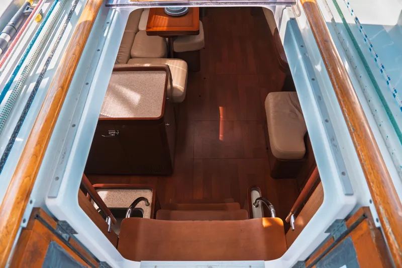 Slide: The Image of Interior view of 2011 Beneteau Oceanis 50 yacht, showcasing elegant wooden flooring and seating area. - 19