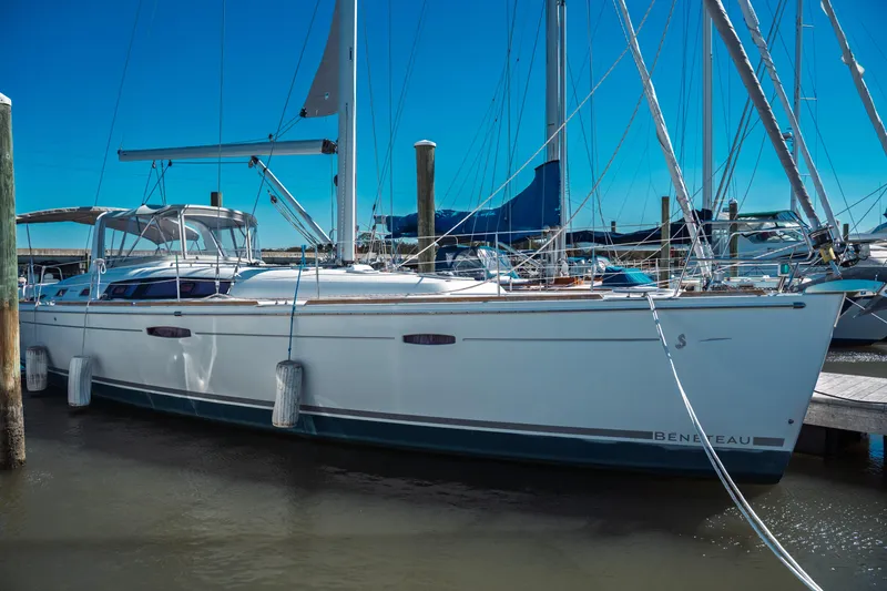 Slide: The Image of 2011 Beneteau Oceanis 50 sailboat docked at marina under clear blue sky. - 2