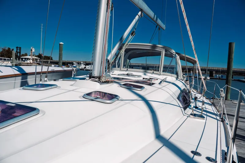 Slide: The Image of 2011 Beneteau Oceanis 50 sailboat docked at marina under clear blue sky. - 20