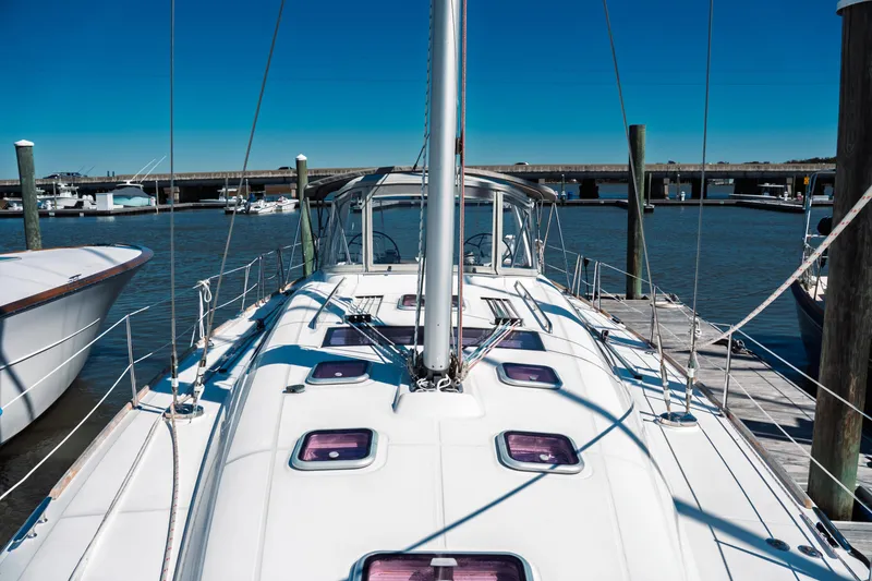 Slide: The Image of 2011 Beneteau Oceanis 50 sailboat docked at marina under clear blue sky. - 21
