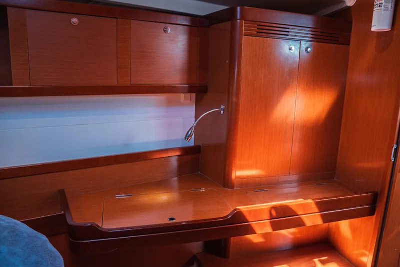 Slide: The Image of Interior of 2011 Beneteau Oceanis 50 yacht with wooden cabinetry and desk. - 23