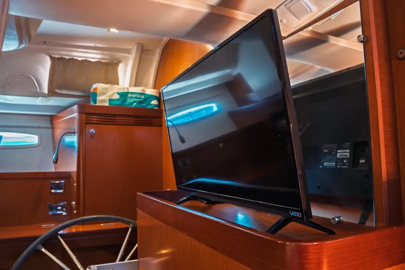 Slide: The Image of Interior of 2011 Beneteau Oceanis 50 yacht with TV and wooden cabinetry. - 29