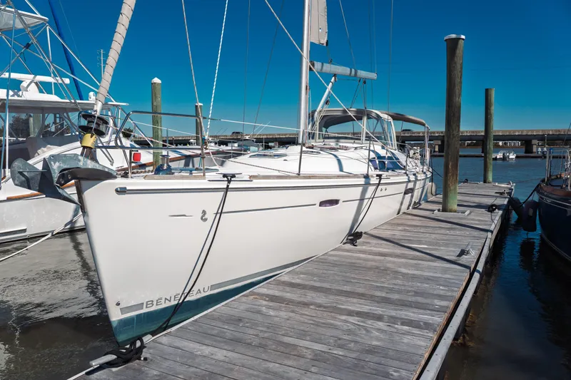Slide: The Image of 2011 Beneteau Oceanis 50 sailboat docked at marina under clear blue sky. - 3