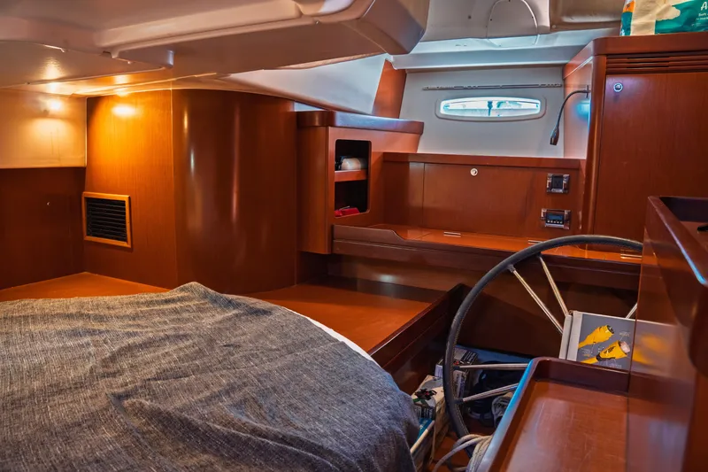 Slide: The Image of Cozy interior of 2011 Beneteau Oceanis 50 sailboat with wooden furnishings and compact design. - 30