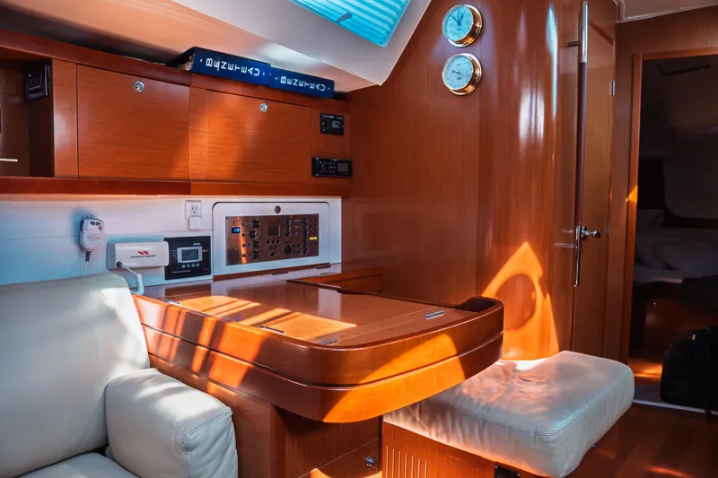 Slide: The Image of Interior of 2011 Beneteau Oceanis 50 yacht with wooden cabinetry and navigation equipment. - 35