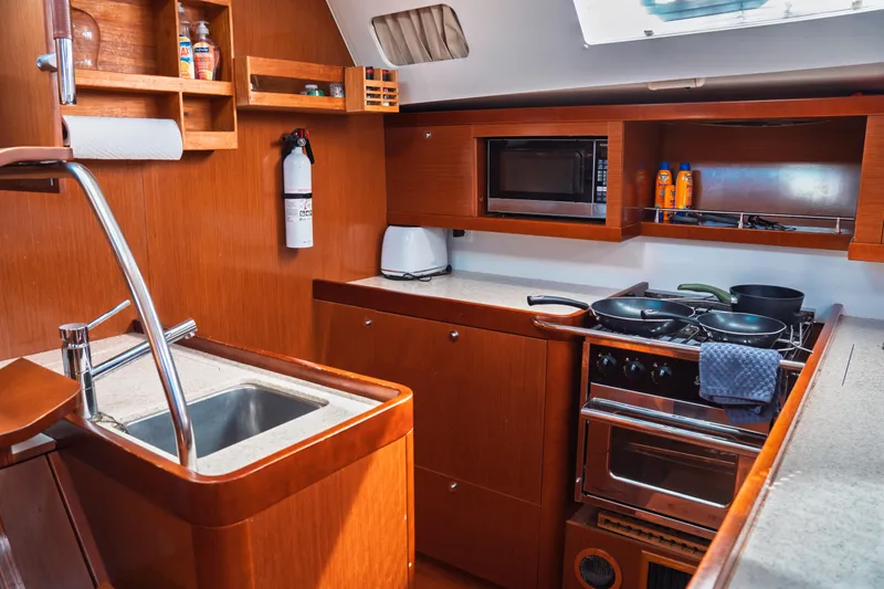 Slide: The Image of Interior of 2011 Beneteau Oceanis 50 yacht kitchen with stove, sink, and microwave. - 40