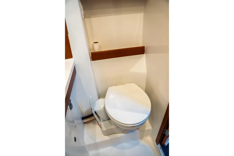 Slide: The Image of Toilet area in 2011 Beneteau Oceanis 50 yacht, featuring compact design and white finish. - 47
