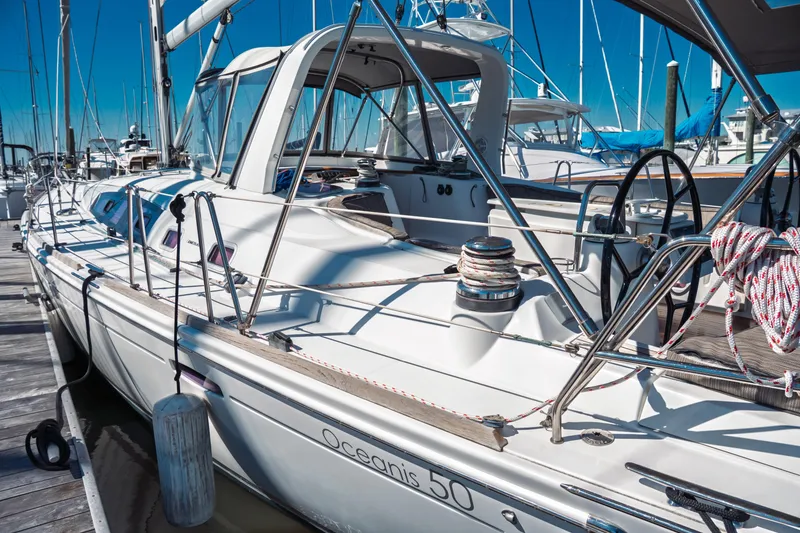 Slide: The Image of 2011 Beneteau Oceanis 50 sailboat docked at marina, showcasing sleek design and rigging. - 5