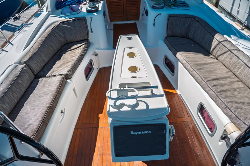 Slide: The Image of Cockpit of 2011 Beneteau Oceanis 50 sailboat with cushioned seating and Raymarine equipment. - 8