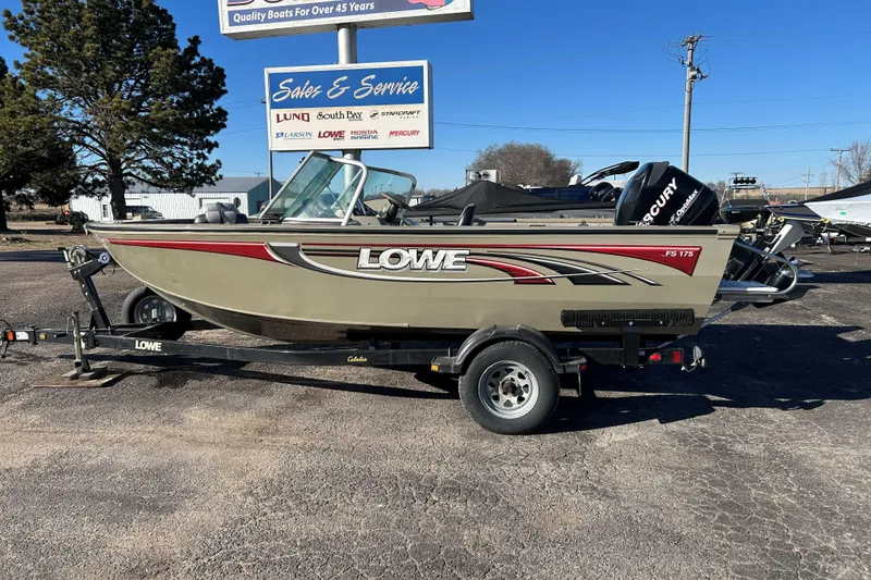 The Image of 2007 Lowe 175 FS boat on trailer at sales and service lot, clear sky background. - 1
