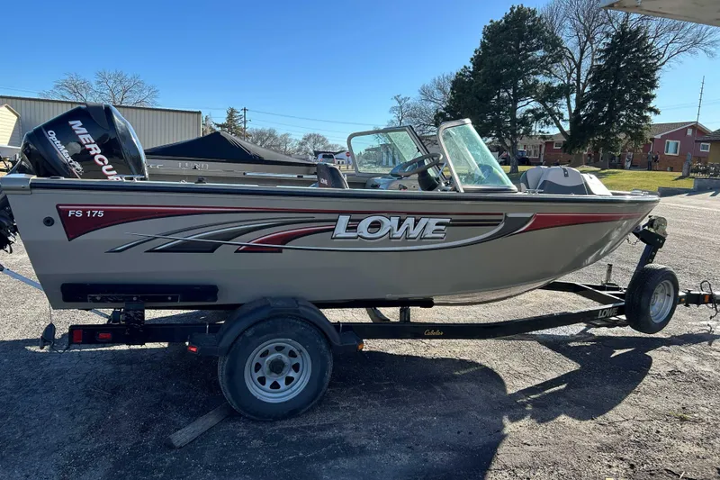 Slide: The Image of 2007 Lowe 175 FS boat on trailer with Mercury outboard motor, parked outdoors. - 3