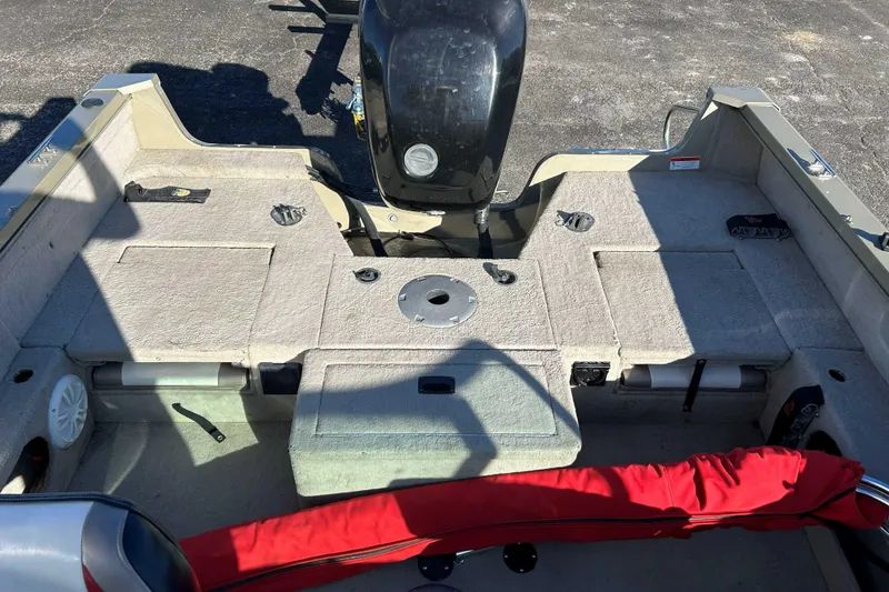 Slide: The Image of 2007 Lowe 175 FS boat interior with motor, featuring spacious seating and storage compartments. - 6