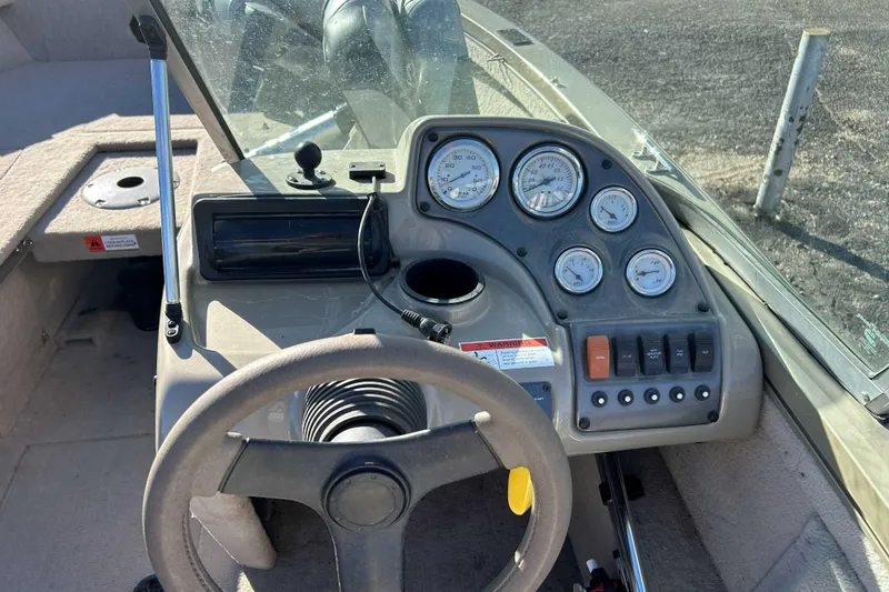 Slide: The Image of 2007 Flowers Lowe 175 FS boat dashboard with steering wheel and gauges. - 7
