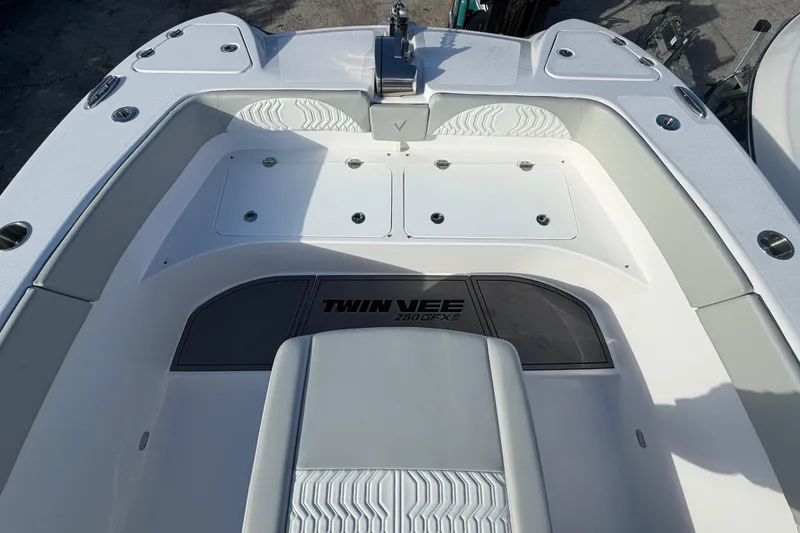 Slide: The Image of 2026 Twin Vee 280 GFX2 CC boat interior, featuring sleek seating and storage compartments. - 11