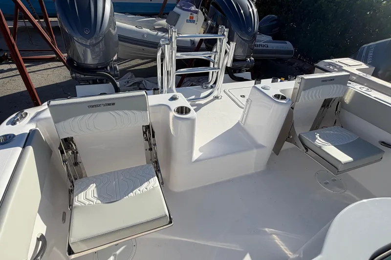 Slide: The Image of 2026 Twin Vee 280 GFX2 CC boat interior with seating and dual outboard motors. - 15