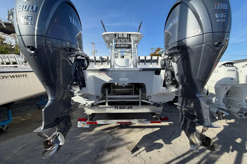 Slide: The Image of 2026 Twin Vee 280 GFX2 CC boat on trailer with ladder and engines. - 17