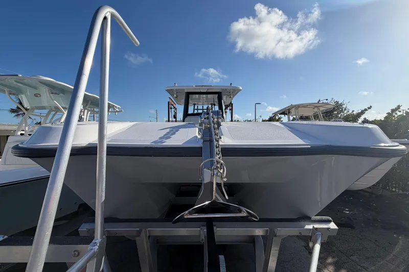 Slide: The Image of 2026 Twin Vee 280 GFX2 CC boat logo on window, showcasing sleek design. - 3