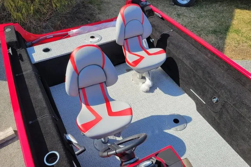 Slide: The Image of 2026 Smoker Craft Lazer 161 boat interior with red and gray seating. - 11