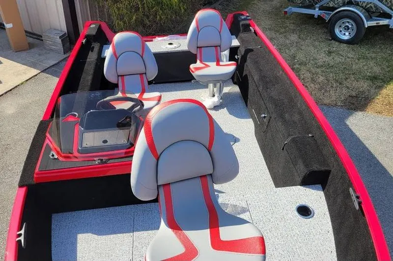 Slide: The Image of 2026 Smoker Craft Lazer 161 boat interior with red and gray seating. - 5
