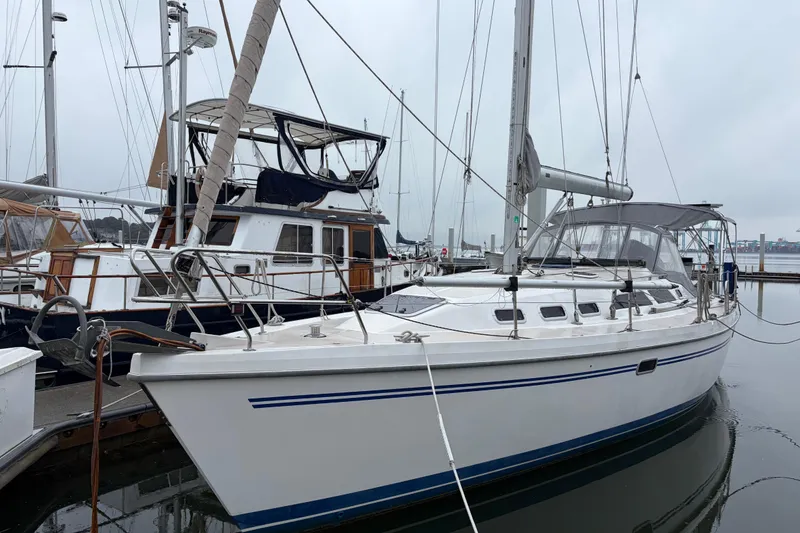 The Image of 1998 Catalina 380 sailboat docked at marina on a cloudy day. - 0