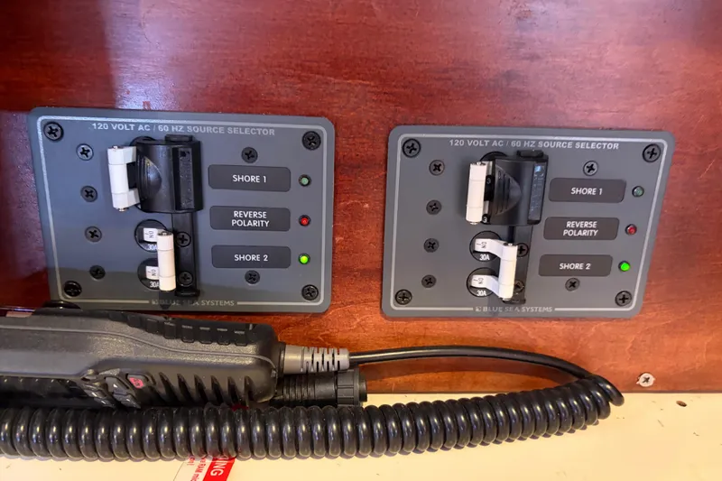 Slide: The Image of Electrical panel on a 1998 Catalina 380 boat with shore power selectors. - 12