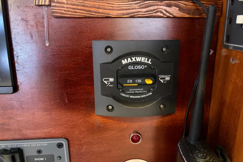 Slide: The Image of Circuit breaker panel on 1998 Catalina 380 sailboat, featuring Maxwell Gloso waterproof ignition protector. - 13