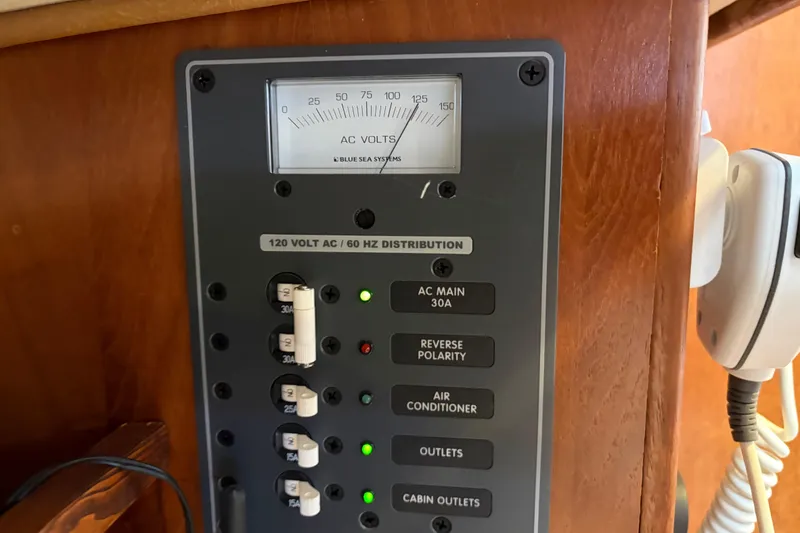 Slide: The Image of Electrical panel on a 1998 Catalina 380 sailboat, featuring AC voltage distribution. - 14