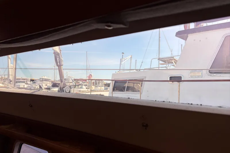 Slide: The Image of View from inside a 1998 Catalina 380 sailboat, overlooking a marina with docked boats. - 19