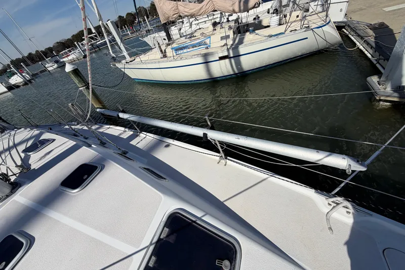 Slide: The Image of Sailboats docked at a marina, featuring a 1998 Catalina 380. - 2