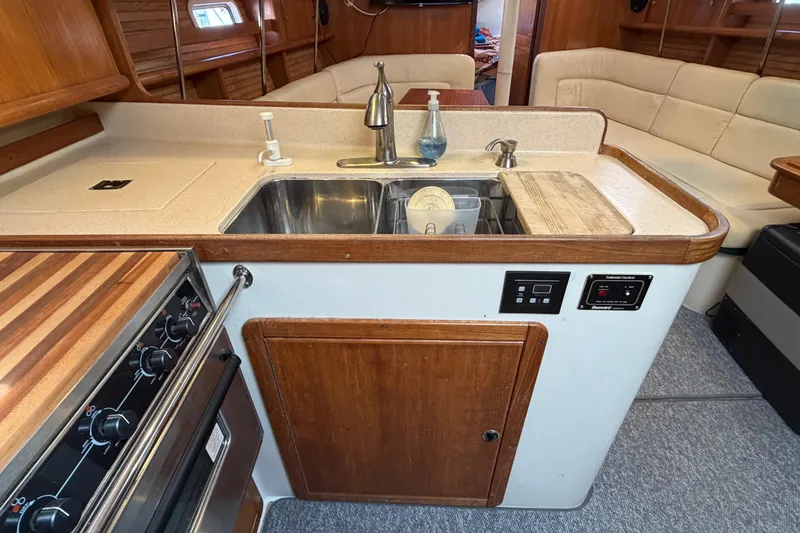 Slide: The Image of Galley kitchen in 1998 Catalina 380 sailboat with sink, stove, and seating area. - 22