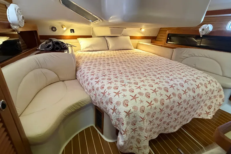 Slide: The Image of Cozy cabin interior of 1998 Catalina 380 sailboat with starfish-patterned bedding. - 26