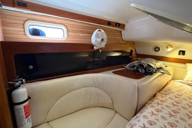 Slide: The Image of Cozy interior of 1998 Catalina 380 sailboat with bed, fan, and fire extinguisher. - 28