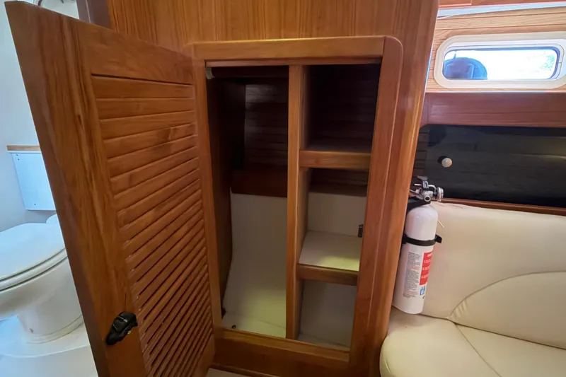 Slide: The Image of Interior of 1998 Catalina 380 sailboat showing wooden cabinet and fire extinguisher. - 30