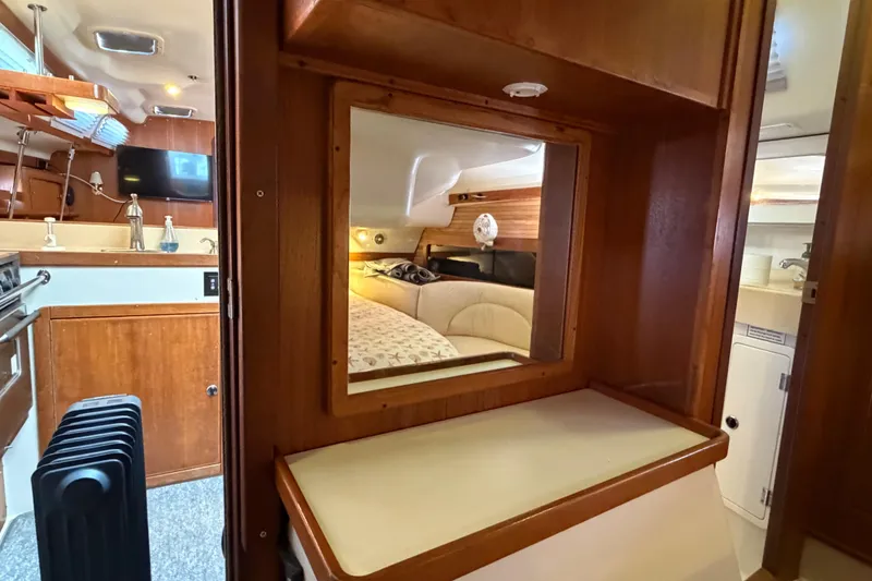 Slide: The Image of Interior of 1998 Catalina 380 sailboat with cozy cabin and wooden furnishings. - 34