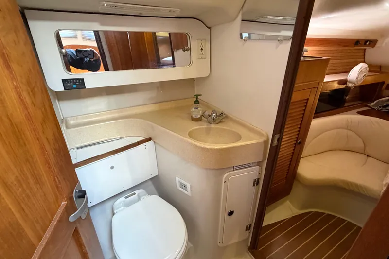 Slide: The Image of Interior of 1998 Catalina 380 yacht bathroom with sink, mirror, and toilet. - 35
