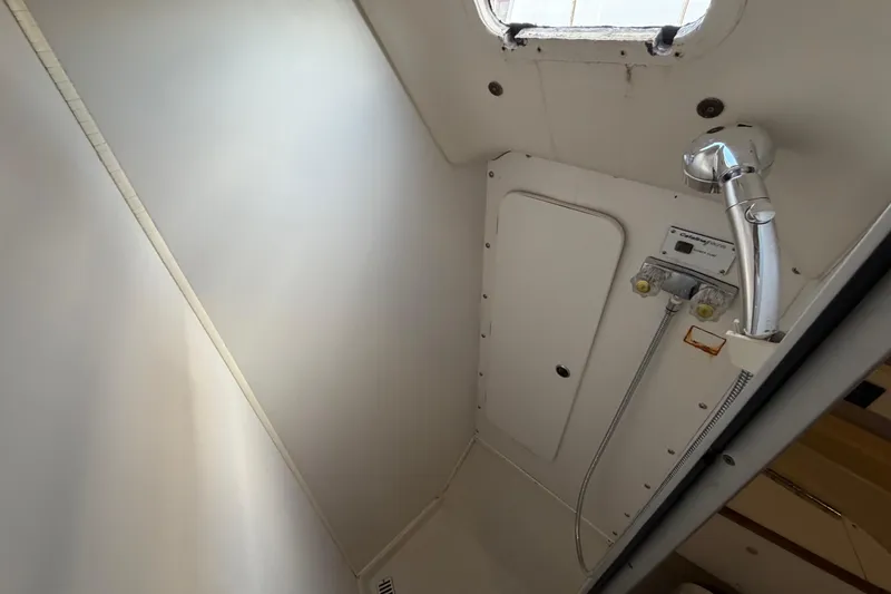 Slide: The Image of Shower area inside a 1998 Catalina 380 sailboat, featuring a compact design and chrome fixtures. - 37