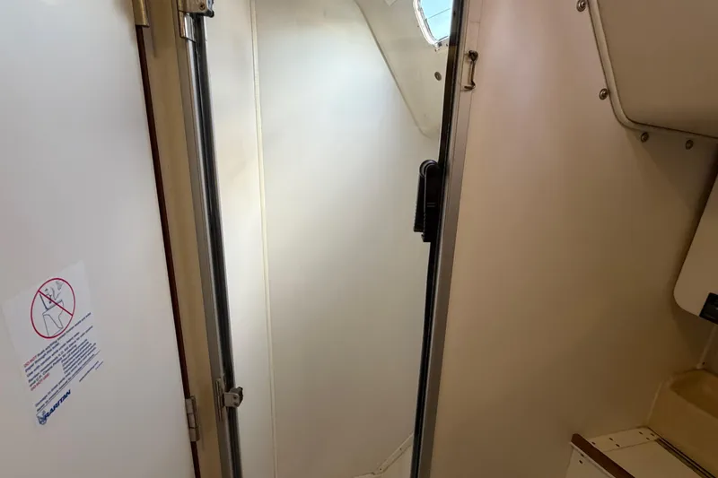 Slide: The Image of Interior of a 1998 Catalina 380 sailboat, featuring a compact cabin space. - 39