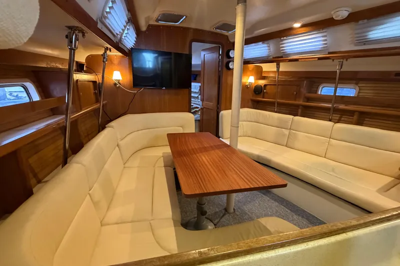 Slide: The Image of Interior of 1998 Catalina 380 sailboat with cozy seating and wooden table. - 4