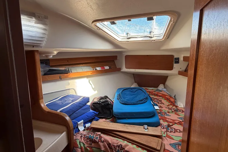 Slide: The Image of Cozy cabin interior of 1998 Catalina 380 sailboat with bedding and storage. - 41